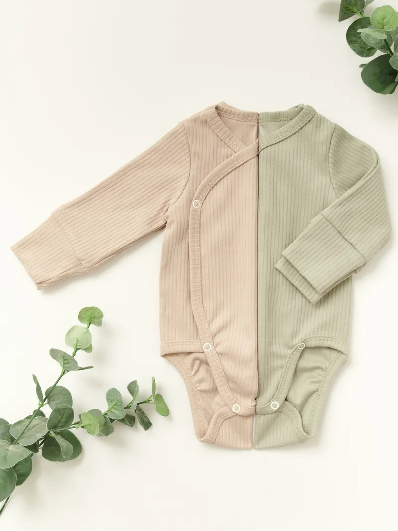 Two-tone baby bodysuit in beige and sage green with eucalyptus styling