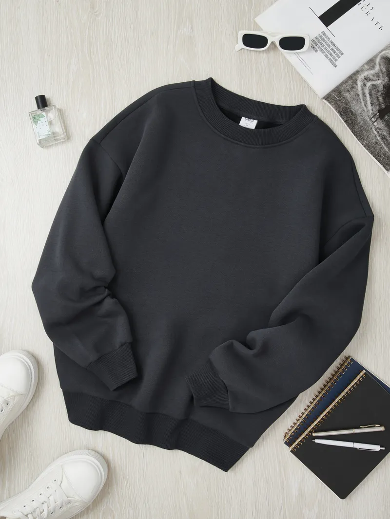 Dark charcoal LENZ sweatshirt with white sneakers sunglasses notebook pens minimalist styling