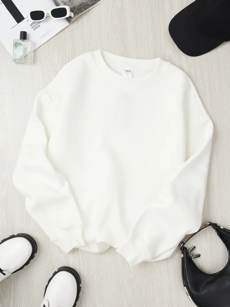 White LENZ sweatshirt with white sunglasses black cap white platform boots black mini bag perfume