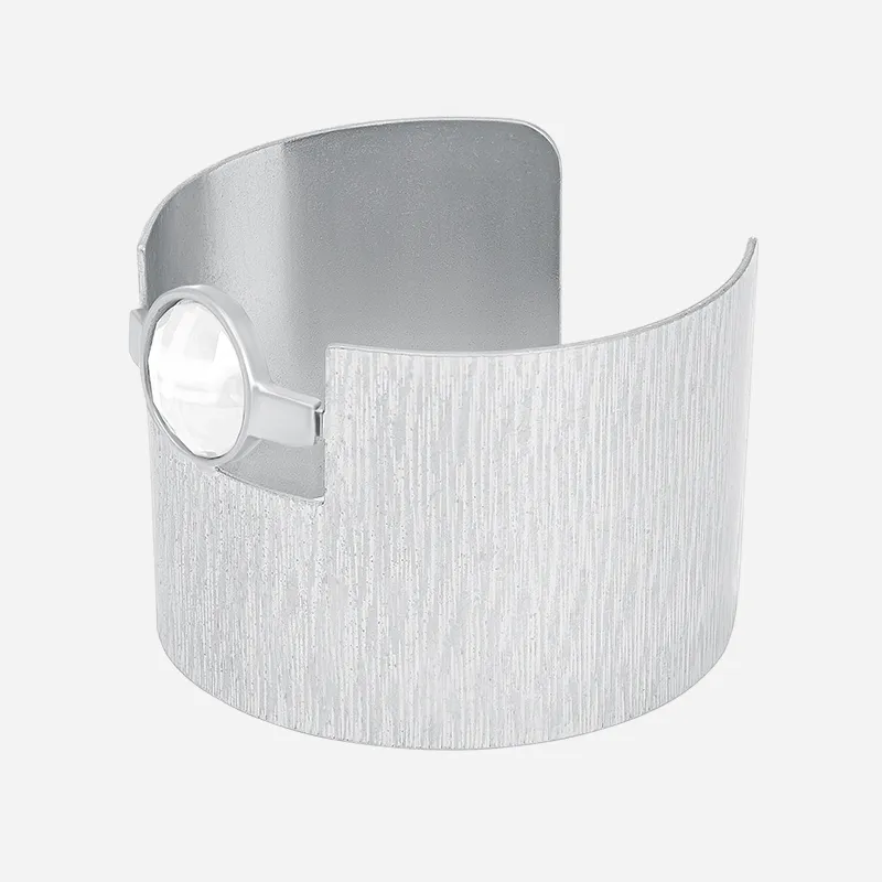 Wide silver cuff bracelet with vertical brushed texture and round crystal cabochon accent